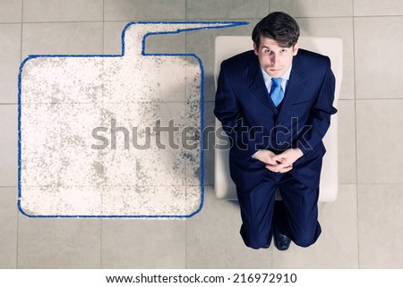 Top view of thoughtful businessman sitting on chair