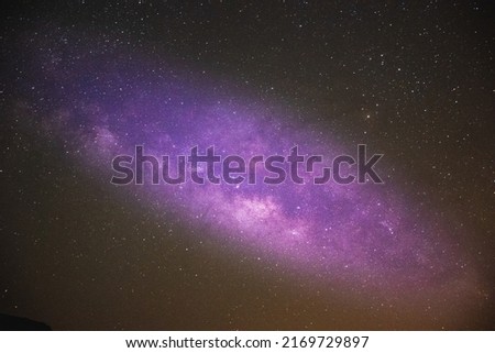 Milky way in the night sky and stars on dark background with noise Photo taken with long exposure and white balance selected.