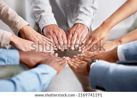 Get hands on, make things happen. Shot of a group of businesspeople joining hands in solidarity.