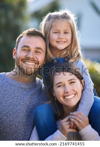 We just want to give her the best childhood. Portrait of a happy family bonding together outdoors.