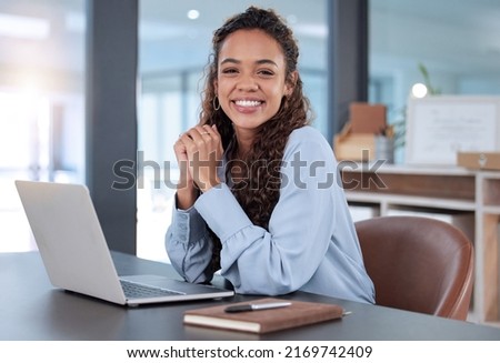 I love what I do. Cropped portrait of an attractive young businesswoman working on her laptop while sitting in the office. Royalty-Free Stock Photo #2169742409