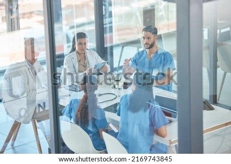 Theyre in a private and confidential session. Shot of a team of medical staff having a meeting.
