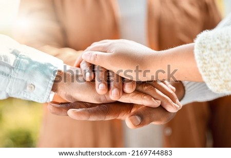 You will love and be loved. Shot of an unrecognizable family of three with their hands in a pile outside. Royalty-Free Stock Photo #2169744883