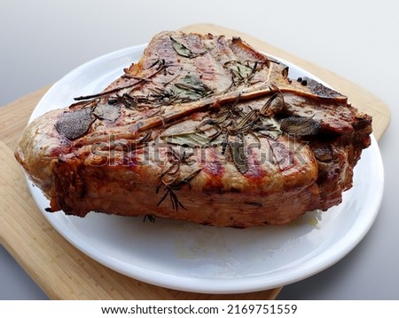 White round plate with Whole grilled T-bone steak isolated on white background Royalty-Free Stock Photo #2169751559