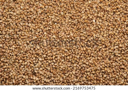 The texture of dry buckwheat. Background image of buckwheat porridge. 