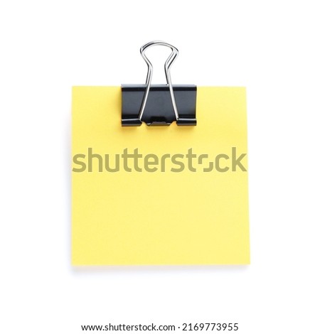 Blank orange note with black paper clamp isolated on white. Space for text