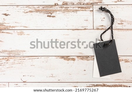 white Blank tag on a light wooden background