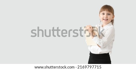 Cute little waiter on light background with space for text