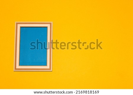 old retro frame with blue copy space on the left side of the background, on the right side yellow part as copy space, creative art design