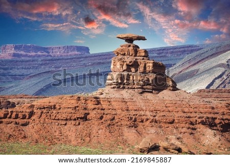 Famous rock Mexican Hat near village of Mexican Hat near Monument Valley, Utah, USA at sunset