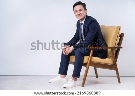 Image of young Asian businessman on background Royalty-Free Stock Photo #2169860889
