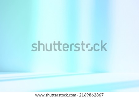 Abstract blue studio background for product presentation. Empty room with shadows of window. Display product with blurred backdrop.