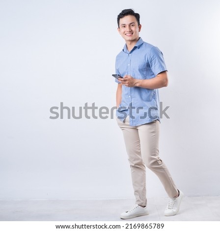 Full length image of young Asian man on white background Royalty-Free Stock Photo #2169865789