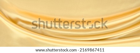 White yellow satin texture that is gray silver fabric silk background with beautiful soft blur pattern natural.