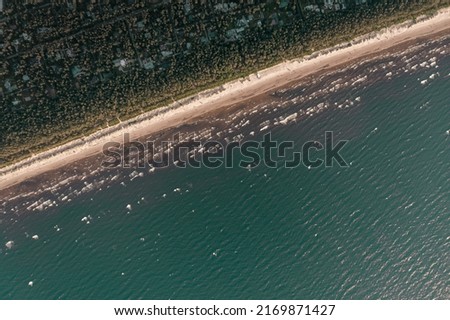 Top view of beautiful white sand beach with turquoise ocean water, aerial drone shot