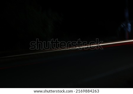 Time-lapse photography of a blurred road with yellow light.