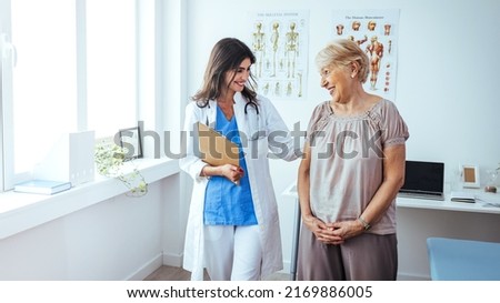 Doctor and patient discussing something at hospital . Medicine and health care concept. Doctor and patient. Patient Having Consultation With Doctor In Office. Doctor consulting with a patient 