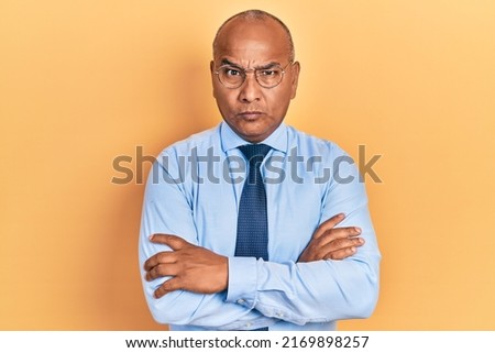 Middle age latin man wearing business clothes with arms crossed gesture skeptic and nervous, frowning upset because of problem. negative person.  Royalty-Free Stock Photo #2169898257