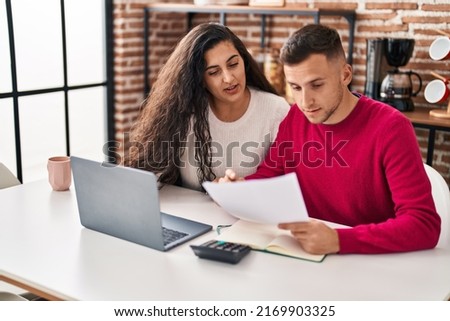 Man and woman couple calculating family economy at home