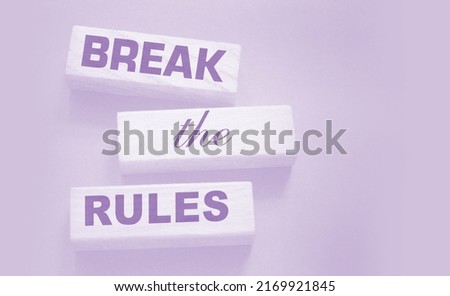 Break the rules phrase on wooden blocks on dark grey. Behavior concept or innovative business management concept