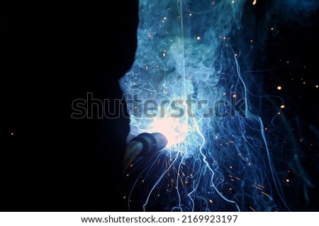 Welding arc. The process of welding products and metal. Sparks fly, smoke.