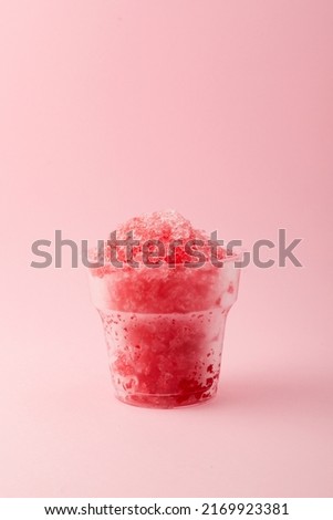 Slushie or Slush - drink on pink background. Fruit shaved ice in disposable plastic cup. Take away food. Refreshing summer drink. Vertical orientation, copy space. Royalty-Free Stock Photo #2169923381