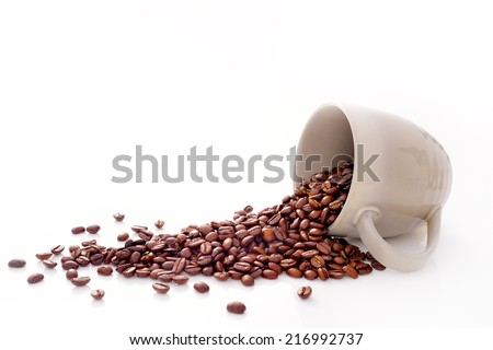 Coffee beans in coffee cup isolated on white Royalty-Free Stock Photo #216992737