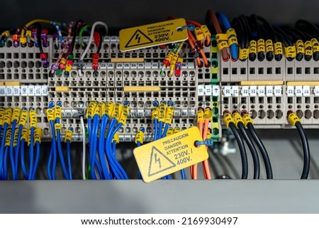 Electric wiring diagram of machinery in industrial factory. Terminal diagram with tag and warning label. High voltage electric wire. Automation machinery control panel. Electrical control cabinet. Royalty-Free Stock Photo #2169930497