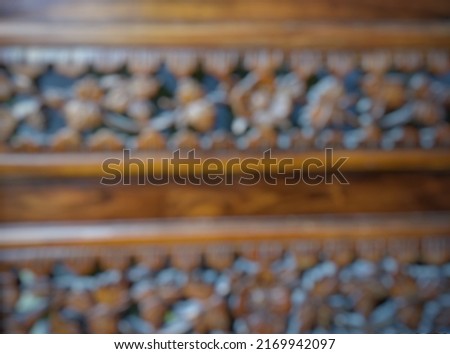 defocused abstract background of brown wood carving. 