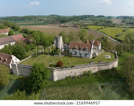 Aerial view of Poncenat castle in central France surrounded by a wall with a semi circular tower Royalty-Free Stock Photo #2169946957