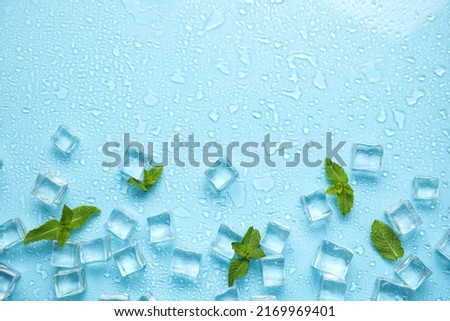 Ice cubes, mint and space for text on turquoise background, flat lay. Refreshing drink ingredients Royalty-Free Stock Photo #2169969401