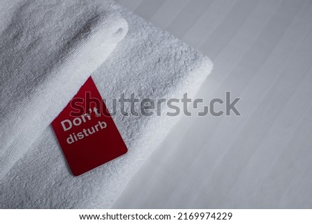 Door hanger with "do not disturb" sign