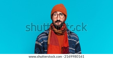young crazy bearded man and wearing winter clothes