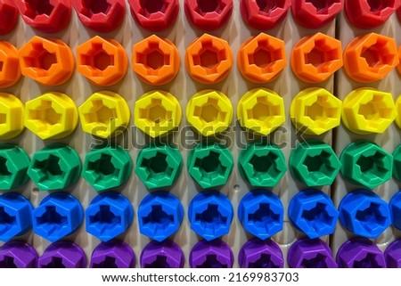 Colorful kids plastic toy bolts and nuts background