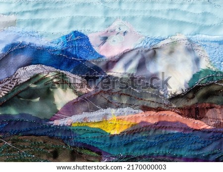 mountain landscape hand-stitched with patchwork technique from various textile pieces