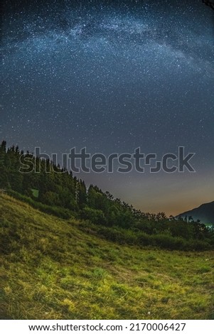 Mountain landscape with starry sky and milky way