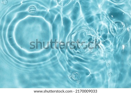 Wavy solar circles, bubbles on the water. Light blue textured background. The perfect solution for any design. Close-up, selective focus