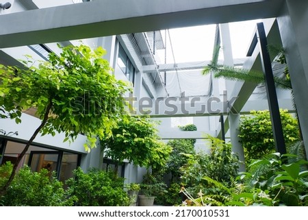 Modern hotel with beautiful garden inside,Eco-friendly. Royalty-Free Stock Photo #2170010531