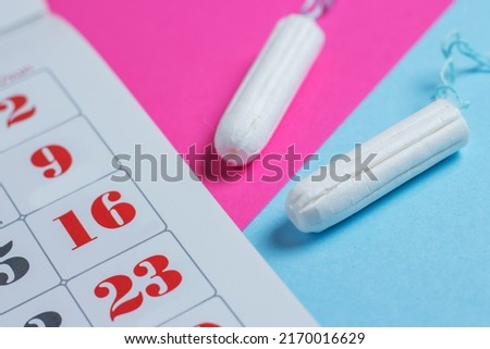 Woman hygiene protection, menstruation calendar and clean cotton tampons