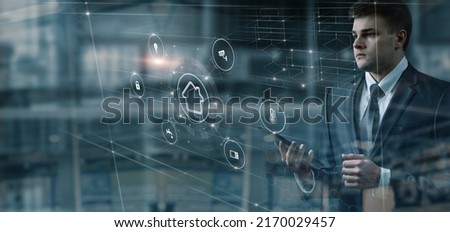Man looking at smart home interface on dark background.