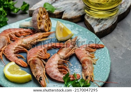 Seafood. Red Argentine shrimps with salt and lemon, Wild shrimps, ocean jumbo shrimps on blue plate. banner, menu, recipe place for text, top view.
