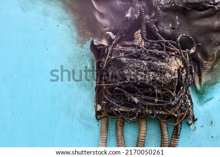 Electrical fire after short circuit in consumer unit, burnt wiring and circuit breakers in switchboard. Royalty-Free Stock Photo #2170050261
