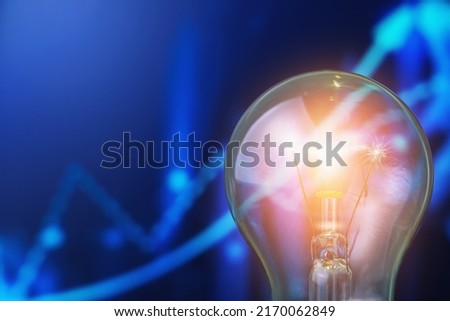 Classic electric light bulb on blurred background trend infographic. The concept of the energy crisis and electricity inflation. Rise in electricity prices. Copy space for text. Royalty-Free Stock Photo #2170062849