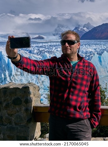 young man on perito moreno glacier, patagonia argentina