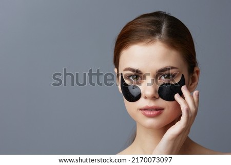 beautiful woman eye patches on face bare shoulders skin care close-up Lifestyle