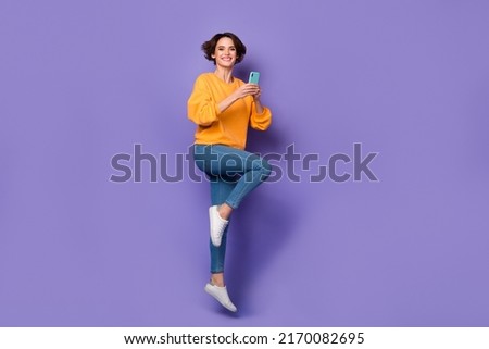 Full length body size view of attractive cheerful girl jumping using gadget blog 5g smm isolated over violet lilac color background