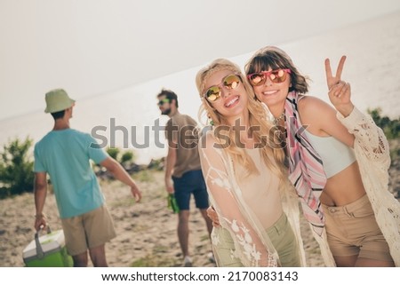 Photo of friendly buddies prepare hipster camp event girl show v-sign wear casual outfit nature seaside beach outdoors