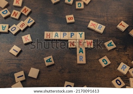 Happy New Year. Party idea for everyone. Wooden letter puzzle game as a way of spending time without social media. High quality photo
