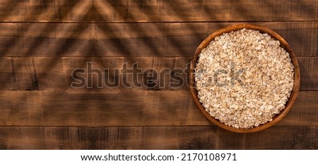 Oat flakes in the wooden bowl - Avena sativa