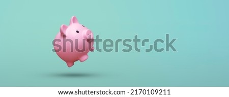 Pink piggy bank floating on blue background Royalty-Free Stock Photo #2170109211